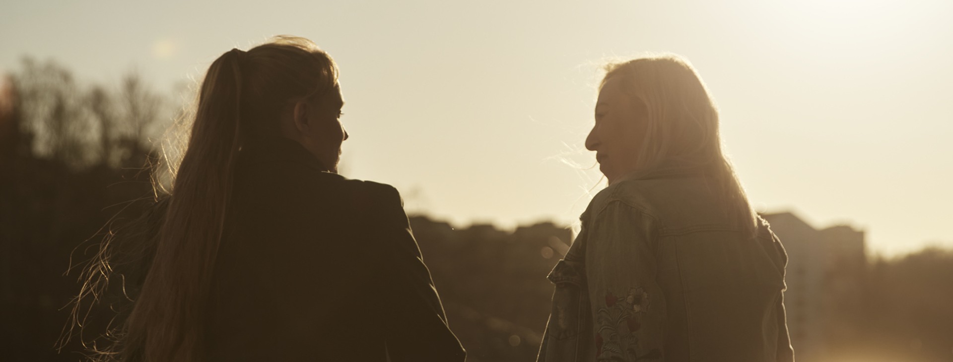 Kvinnor i vårsol som pratar.