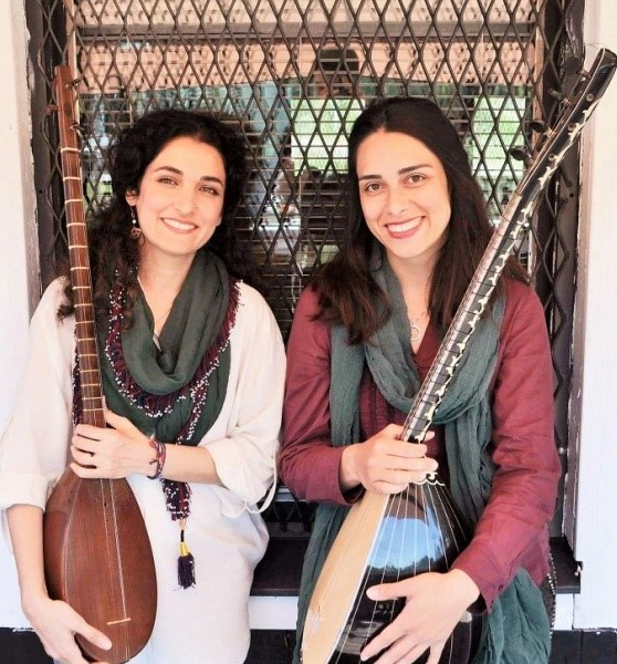 Två kvinnor håller i stränginstrument